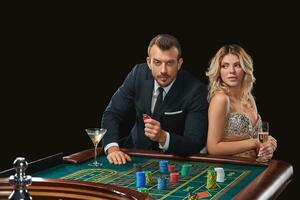 Couple playing roulette wins at the casino. photo