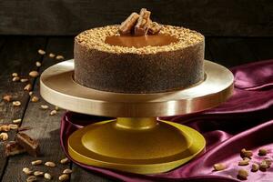Cheesecake with salted caramel, peanuts and chocolate bar photo
