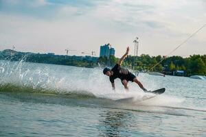 Man balancing on wakeboard trying to make grab photo