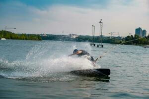 Wakeboarder cutting water with edge of board creating splashes photo