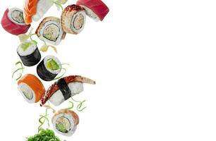 Assorted sushi with pickled ginger and wakame hovering on white background photo