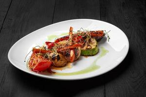 Grilled zucchini, tomatoes, onion and mushrooms with seared carrot photo