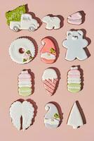 Gingerbreads of different shapes with sugar icing on pinkish background photo