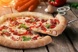 Slice of pizza with sausages, smoked chicken, mushrooms, bell peppers, onions photo