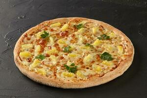 Hawaiian Pizza with cheese, ham, pineapple and bacon photo