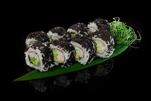 California rolls in black tobiko with crab, avocado, cucumber photo