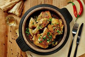 Fried chicken in garlic sauce with greens, shotis puri and chacha photo