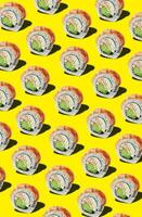 Food pattern of rolls with shrimp on yellow background photo