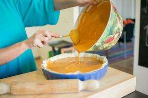 Unrecognizable woman cooking pumpkin cake photo