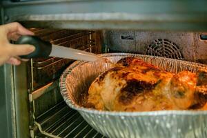 Thanksgiving turkey in oven must be kept moist. photo