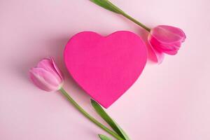 Valentine's day concept. Pink heart and tulips. Greeting card photo