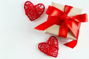 Valentine's day gift and red hearts on a white background photo