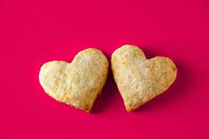 Heart shaped cookies for valentines day on pink background photo