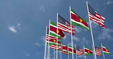 United States and Suriname Flags Waving Together in the Sky, Seamless Loop in Wind, Space on Left Side for Design or Information, 3D Rendering video