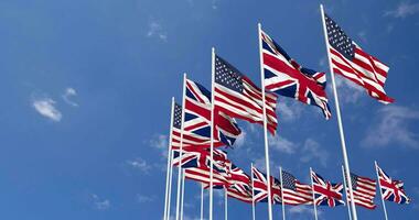 United States and United Kingdom Flags Waving Together in the Sky, Seamless Loop in Wind, Space on Left Side for Design or Information, 3D Rendering video