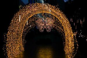 Abstract blur bokeh of the Christmas and New Year's Day illumination is shaped like a tunnel and butterflies. photo