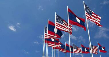 United States and Laos Flags Waving Together in the Sky, Seamless Loop in Wind, Space on Left Side for Design or Information, 3D Rendering video