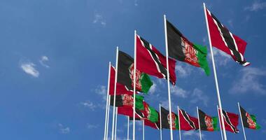 Afghanistan and Trinidad and Tobago Flags Waving Together in the Sky, Seamless Loop in Wind, Space on Left Side for Design or Information, 3D Rendering video