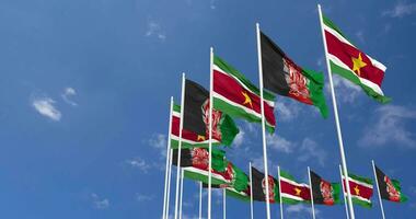 Afghanistan and Suriname Flags Waving Together in the Sky, Seamless Loop in Wind, Space on Left Side for Design or Information, 3D Rendering video