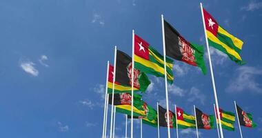 Afghanistan and Togo Flags Waving Together in the Sky, Seamless Loop in Wind, Space on Left Side for Design or Information, 3D Rendering video