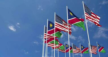United States and Namibia Flags Waving Together in the Sky, Seamless Loop in Wind, Space on Left Side for Design or Information, 3D Rendering video