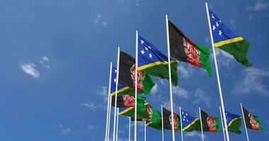 Afghanistan and Solomon Islands Flags Waving Together in the Sky, Seamless Loop in Wind, Space on Left Side for Design or Information, 3D Rendering video