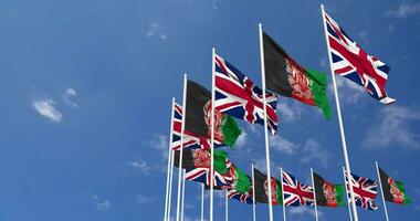 Afghanistan and United Kingdom Flags Waving Together in the Sky, Seamless Loop in Wind, Space on Left Side for Design or Information, 3D Rendering video