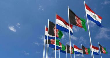 Afghanistan and Paraguay Flags Waving Together in the Sky, Seamless Loop in Wind, Space on Left Side for Design or Information, 3D Rendering video