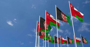 Afghanistan and Oman Flags Waving Together in the Sky, Seamless Loop in Wind, Space on Left Side for Design or Information, 3D Rendering video