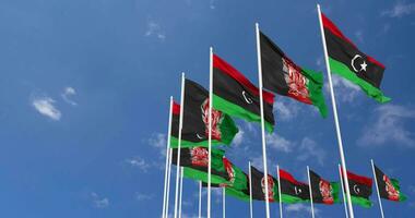 Afghanistan and Libya Flags Waving Together in the Sky, Seamless Loop in Wind, Space on Left Side for Design or Information, 3D Rendering video