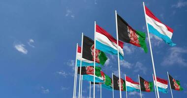 Afghanistan and Luxembourg Flags Waving Together in the Sky, Seamless Loop in Wind, Space on Left Side for Design or Information, 3D Rendering video