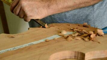 Luthier manufacturing a instrument with a chisel video