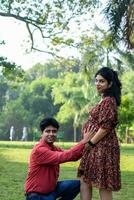 Indian couple posing for Maternity shoot pose for welcoming new born baby in Lodhi Road in Delhi India, Maternity photo shoot done by parents for welcoming their child, Pre Baby Photo Shoot