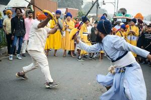 Delhi, India, October 2, 2023 - Sikhs display gatka and martial arts during annual Nagar Kirtan, Traditional, procession on account of birthday of Guru Nanak Dev ji, Nagar Kirtan in East Delhi area photo