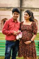 Indian couple posing for Maternity shoot pose for welcoming new born baby in Lodhi Road in Delhi India, Maternity photo shoot done by parents for welcoming their child, Pre Baby Photo Shoot