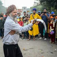 Delhi, India, October 2, 2023 - Sikhs display gatka and martial arts during annual Nagar Kirtan, Traditional, procession on account of birthday of Guru Nanak Dev ji, Nagar Kirtan in East Delhi area photo