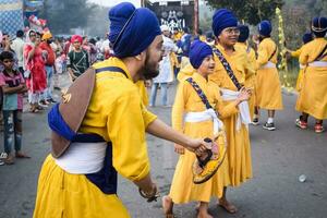 Delhi, India, October 2, 2023 - Sikhs display gatka and martial arts during annual Nagar Kirtan, Traditional, procession on account of birthday of Guru Nanak Dev ji, Nagar Kirtan in East Delhi area photo