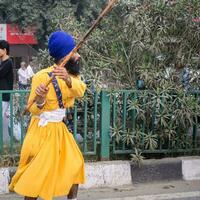 Delhi, India, October 2, 2023 - Sikhs display gatka and martial arts during annual Nagar Kirtan, Traditional, procession on account of birthday of Guru Nanak Dev ji, Nagar Kirtan in East Delhi area photo