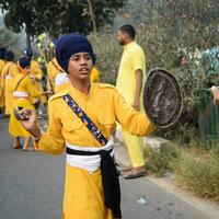 Delhi, India, October 2, 2023 - Sikhs display gatka and martial arts during annual Nagar Kirtan, Traditional, procession on account of birthday of Guru Nanak Dev ji, Nagar Kirtan in East Delhi area photo