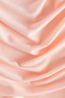 Soft pleats of peach colored satin textiles. Luxury abstract textile background design. Vertical view. Color of the Year 2024 peachy fuzz. photo