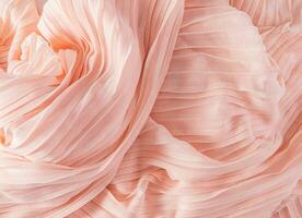 Delicate air waves of peach-colored silk or chiffon fabric. Layout for design. Background image for holiday decor. Color of the Year 2024 Peach Fuzz. photo