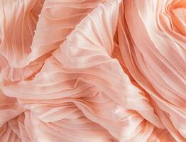 Soft air waves of peach-colored silk or chiffon fabric. Chic abstract festive background. Design mockup. Color of the Year 2024 Peach Fuzz. photo