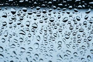 Rain drops cling to the car windshield, selective focus, soft focus. photo