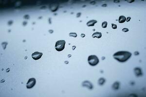 Rain drops cling to the car windshield, selective focus, soft focus. photo