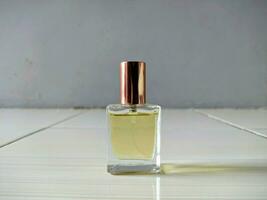 perfume bottle with gold cap on the floor photo