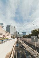 View of the four-lane highway running through Den Haag on a sunny day past the skyscrapers. Traffic in the Netherlands photo