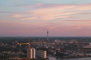 Aerial view of nightlife in the modern city of Rotterdam in the Netherlands. Red glow from the setting sun in the background photo