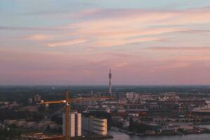 Aerial view of nightlife in the modern city of Rotterdam in the Netherlands. Red glow from the setting sun in the background photo