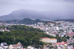 View on roofs in the city of Dalat. Da Lat and the surrounding area is a popular tourist destination of Asia. City with fogs and mountains photo