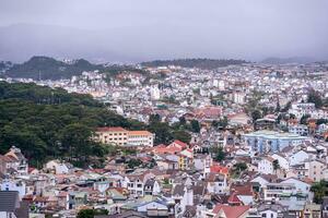 View on roofs in the city of Dalat. Da Lat and the surrounding area is a popular tourist destination of Asia. City with fogs and mountains photo